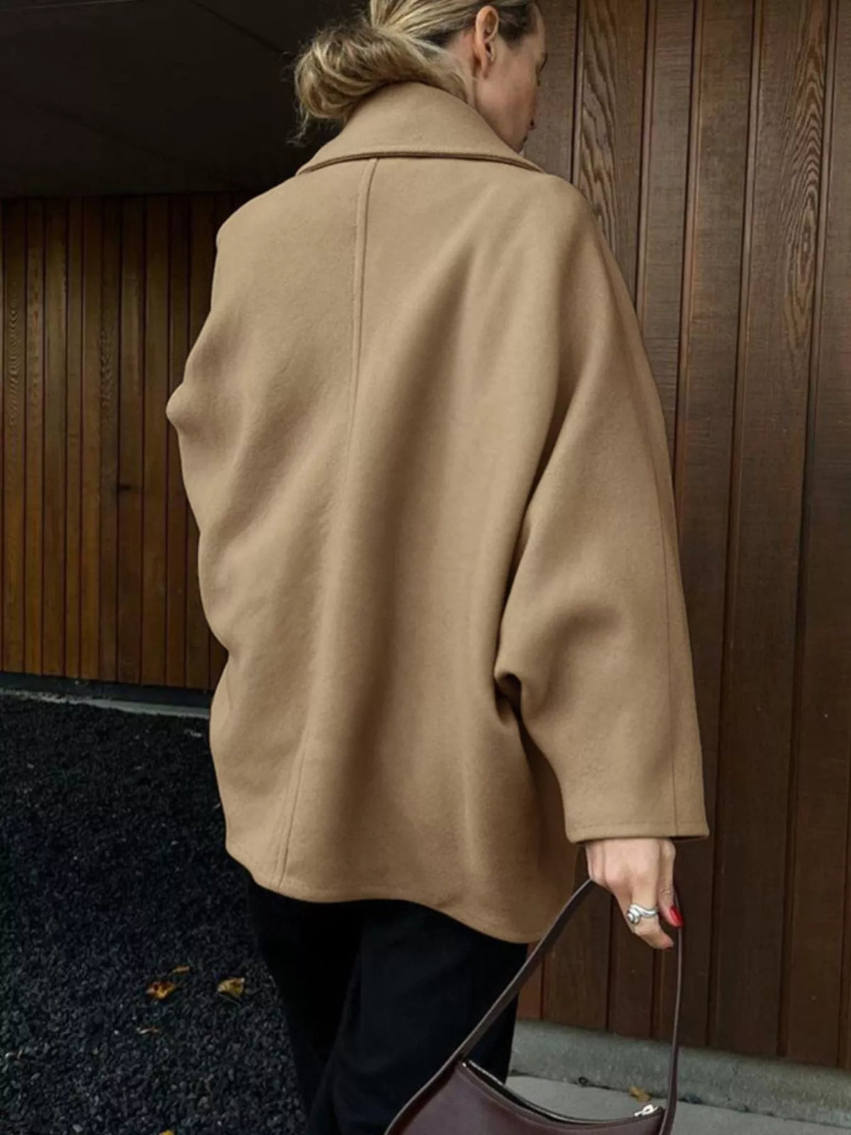 Khaki button-up coat back view with relaxed fit and long, wide sleeves