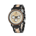 Two-tone round quartz wristwatch with black bracelet, beige pads, and white dial