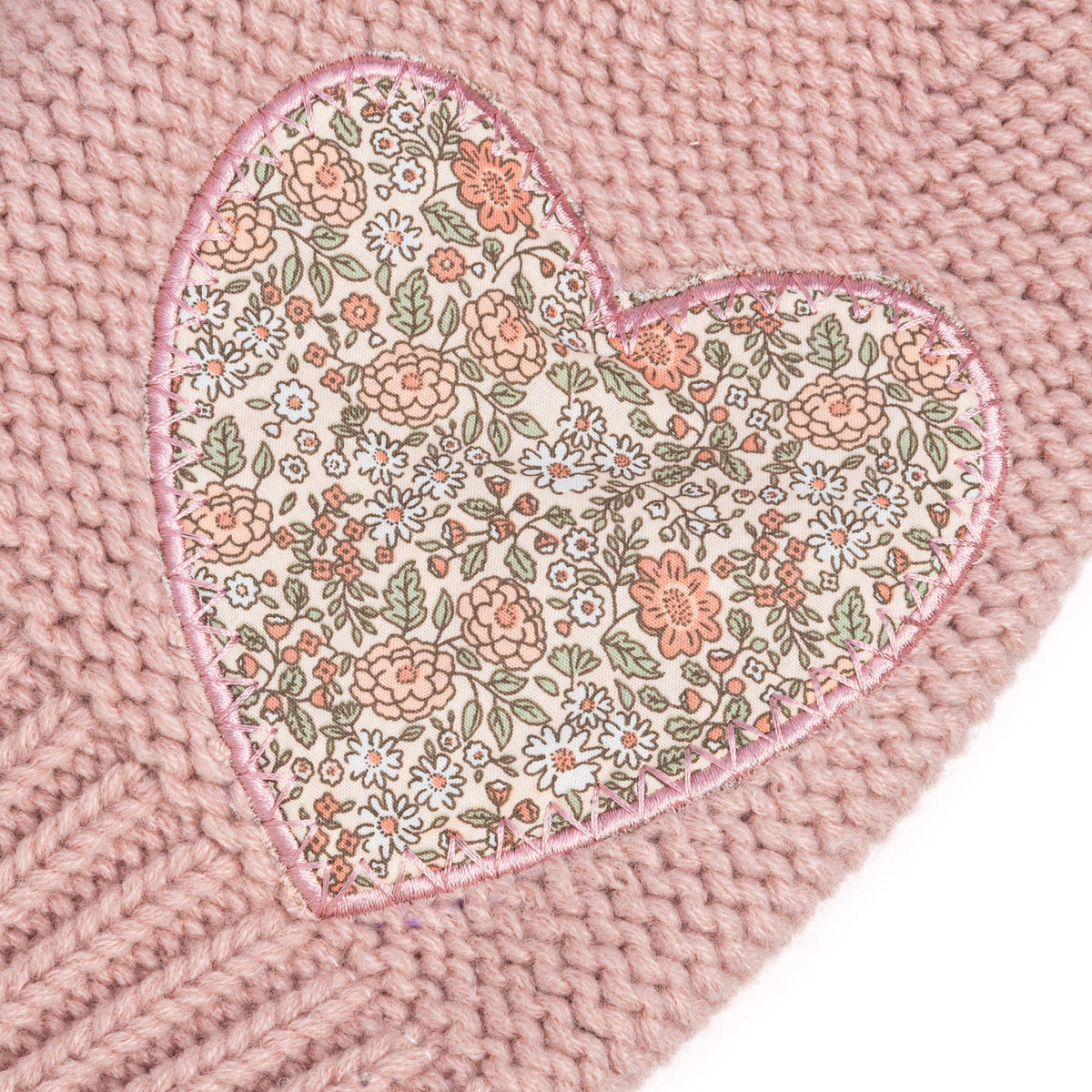 Close-up of mauve knit mittens with beige rabbit faces and stitched pink ears