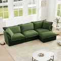 Green L-shaped slipcovered sectional sofa with cushioned seats, back pillows, and chaise