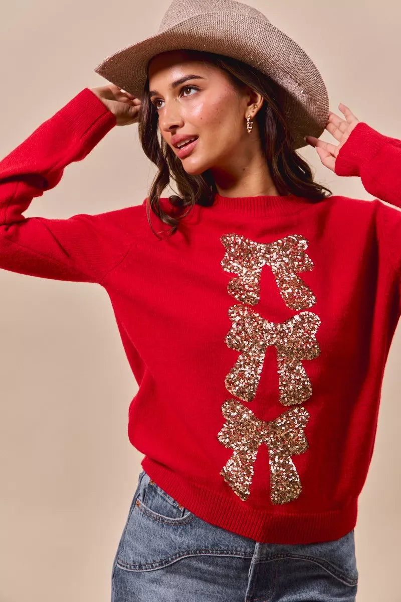Red crewneck sweater with gold sequin bow ribbon applique down the center