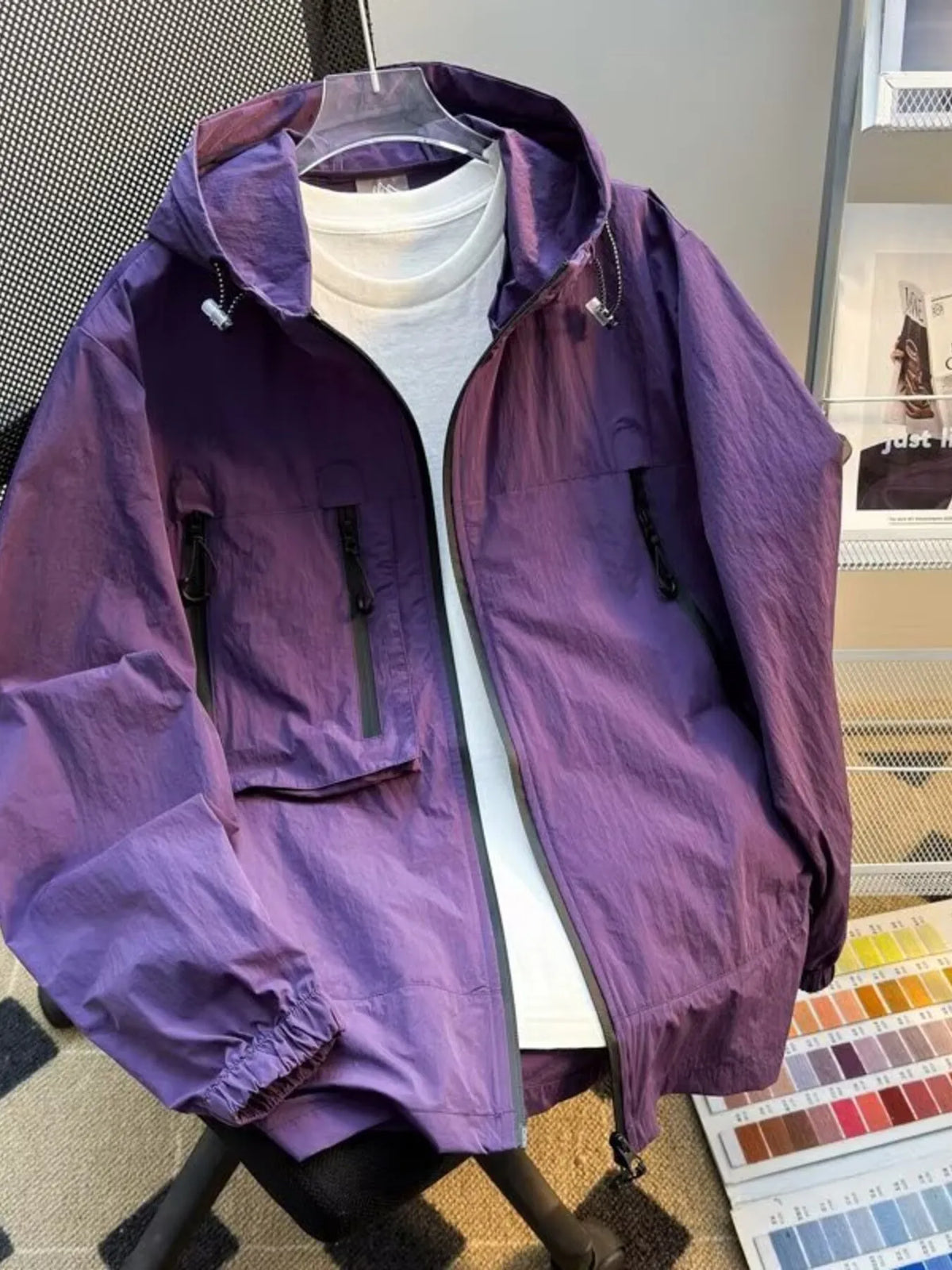 Lightweight hooded windbreaker jacket in purple with full zip and front utility pockets