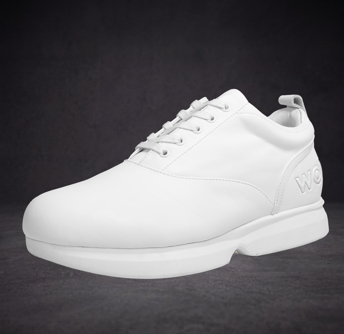 White sneaker side with lace eyelets and thick outsole for everyday wear