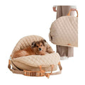 Light tan quilted pet carrier with padded nest, buckles, and carrying handles