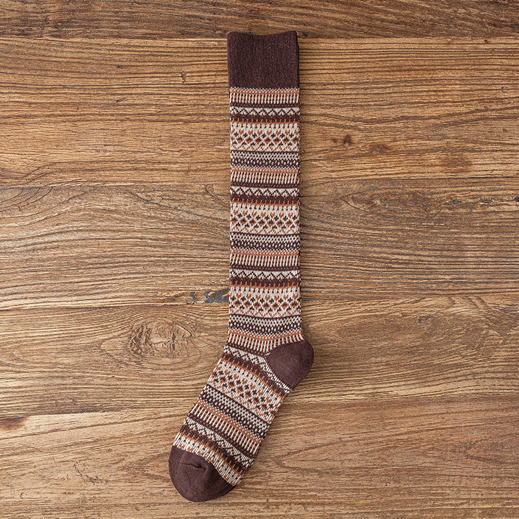 Children’s knee-length socks in dark brown with multicolor geometric striped knit.