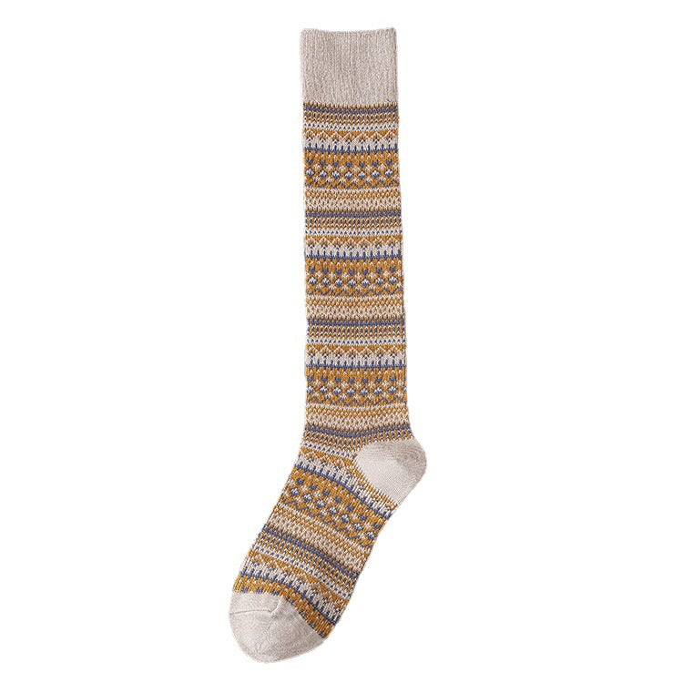 Children’s knee-length socks in light gray with orange, blue, and cream patterned stripes.