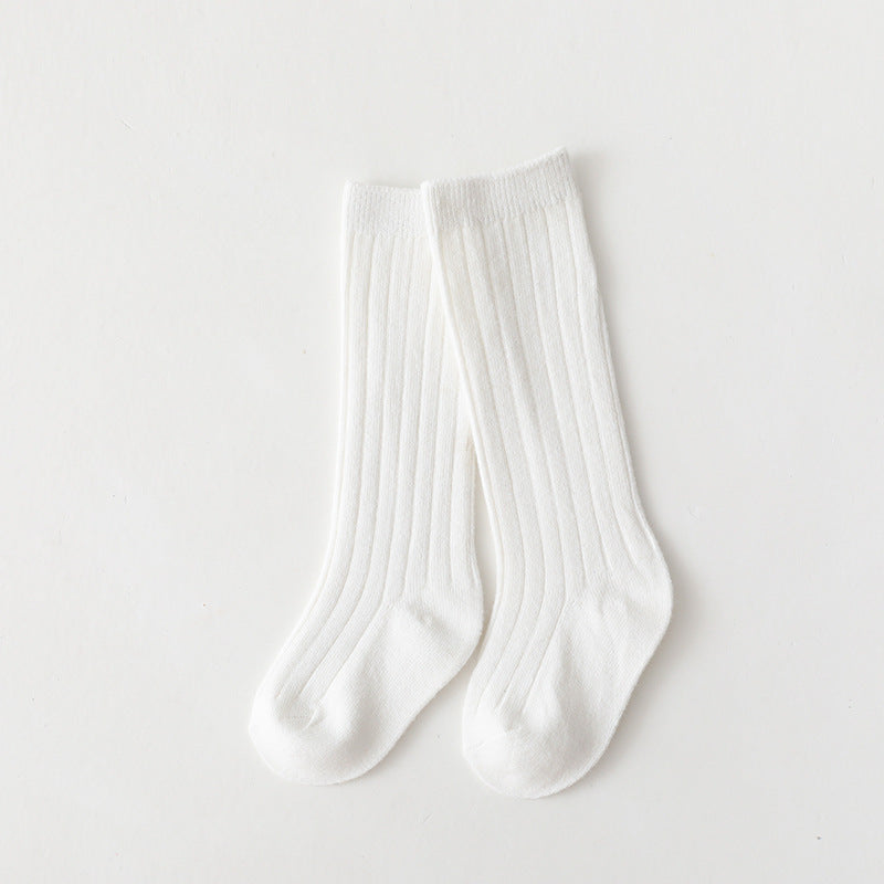 Pair of white mid-calf ribbed baby socks.