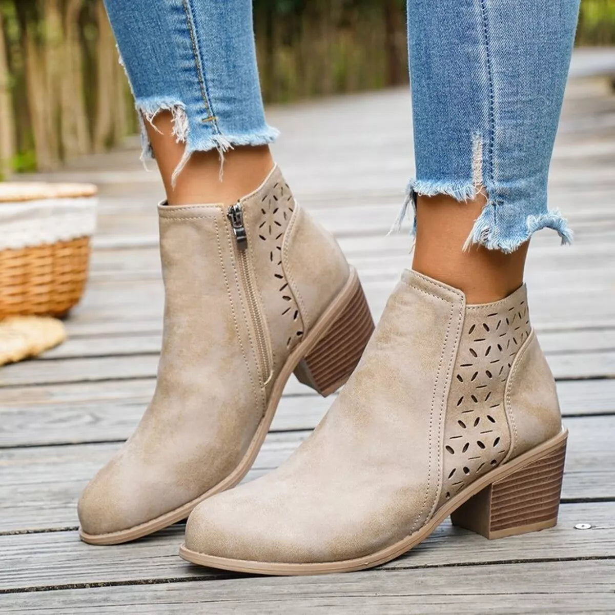 Beige ankle boots with block heel, side zipper, and cutout perforation panels