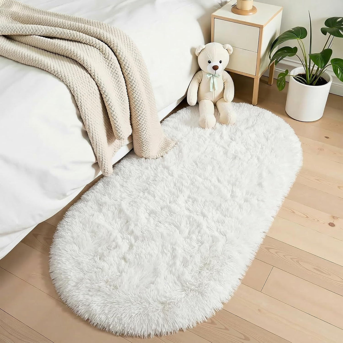 Ivory fluffy oval shag rug with long pile and rounded edges