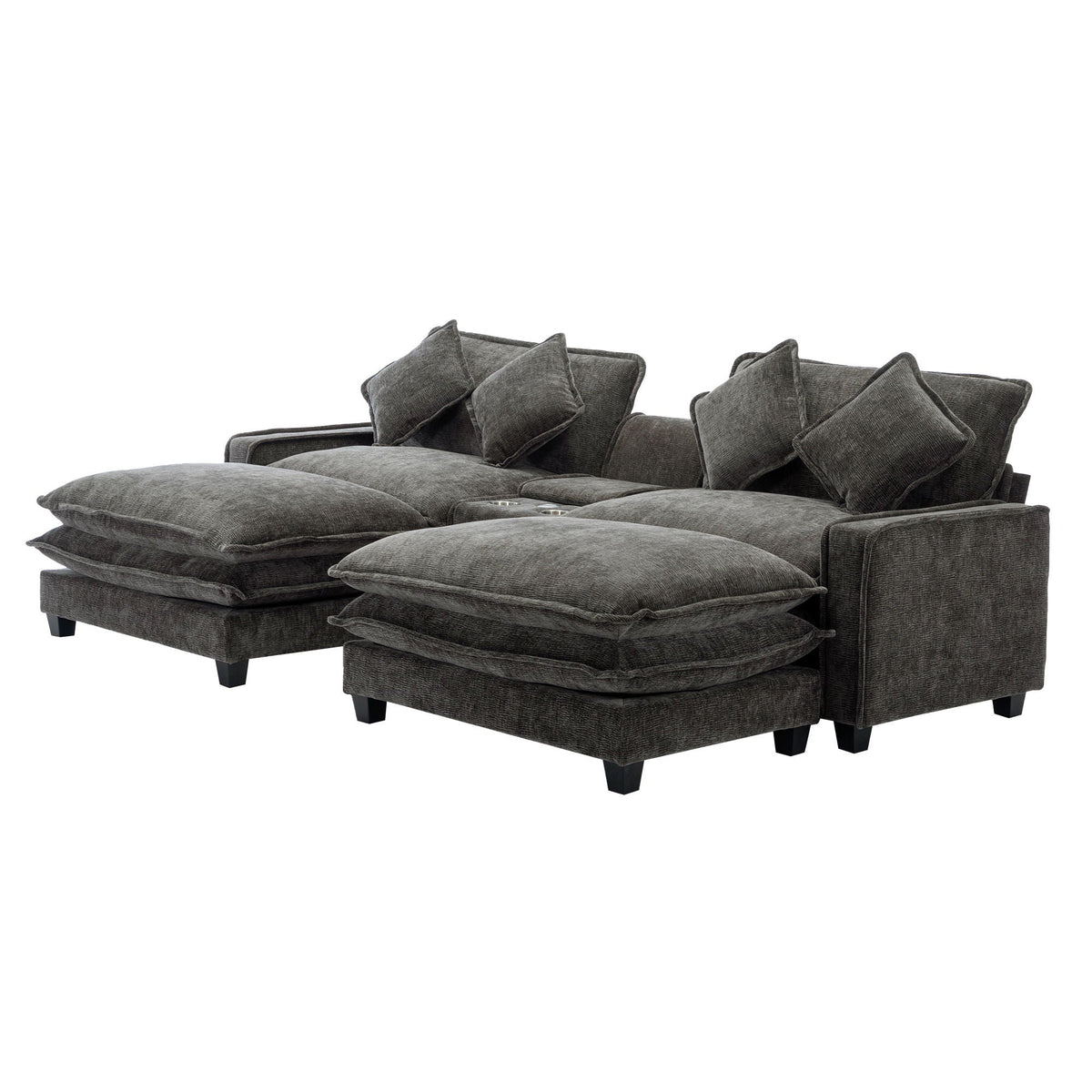 Dark gray sectional sofa with stacked ottoman seats and several back throw pillows
