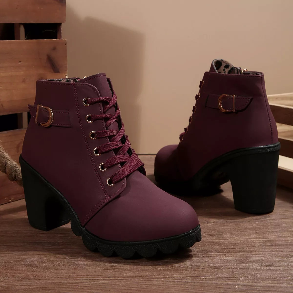 Burgundy lace-up ankle boots with chunky heel, buckle collar detail and rugged tread sole