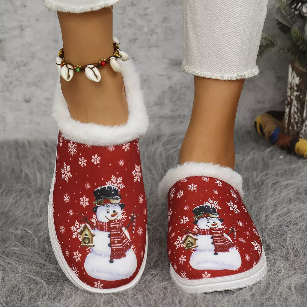 Red plush-lined Christmas slippers with snowman print, white trim, and non-slip sole