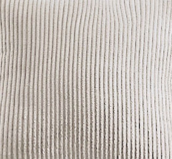 Close-up of ribbed cream/white corduroy fabric for a sectional sofa