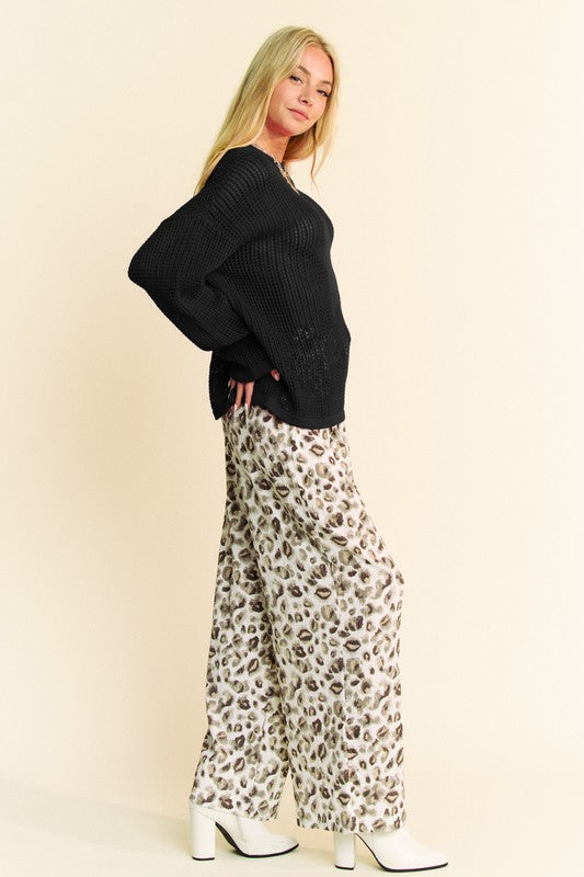 Black star-front crochet knit sweater in side view with wide drop-shoulder cuff