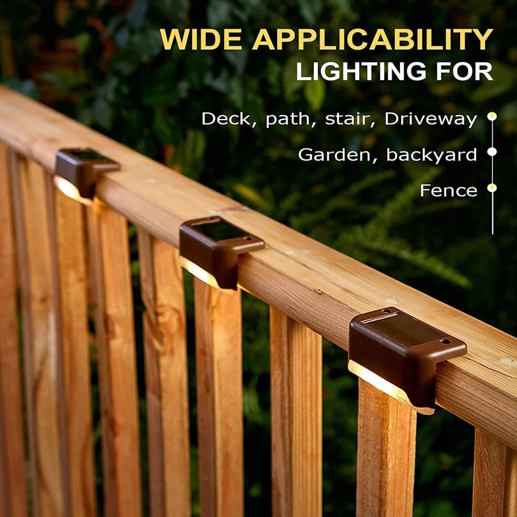 Solar LED deck lights clipped to wooden deck railing, warm light bar
