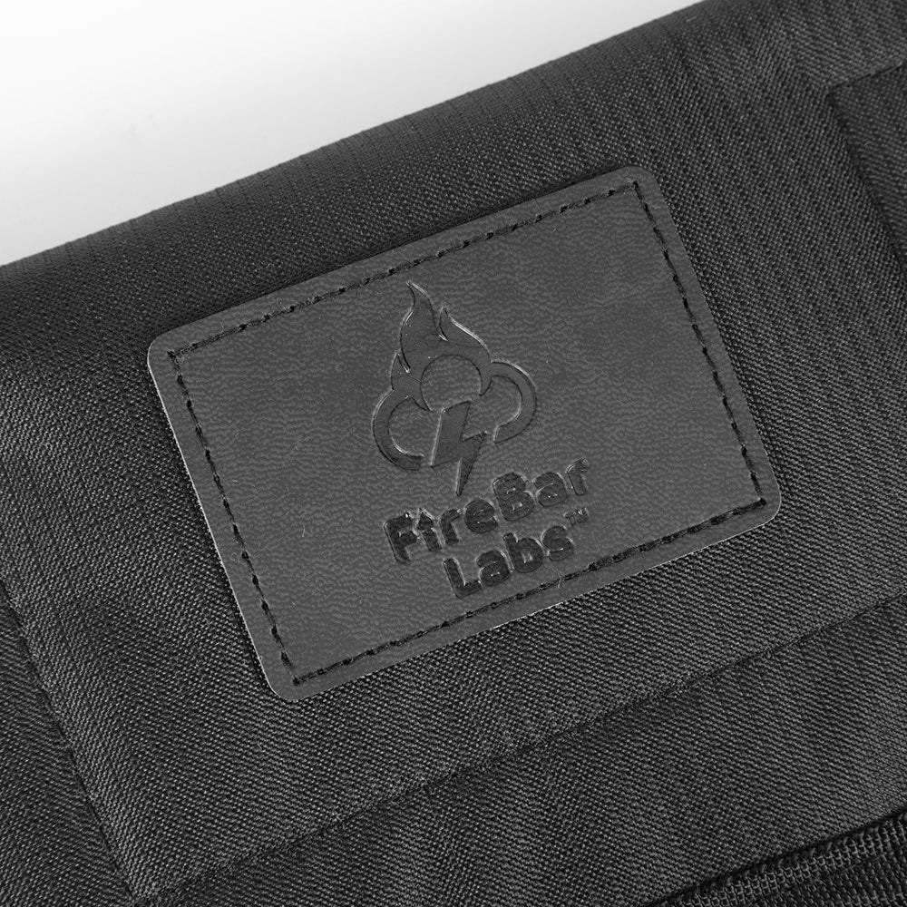 Smell proof travel wallet detail with embossed FireBar Labs label on dark fabric