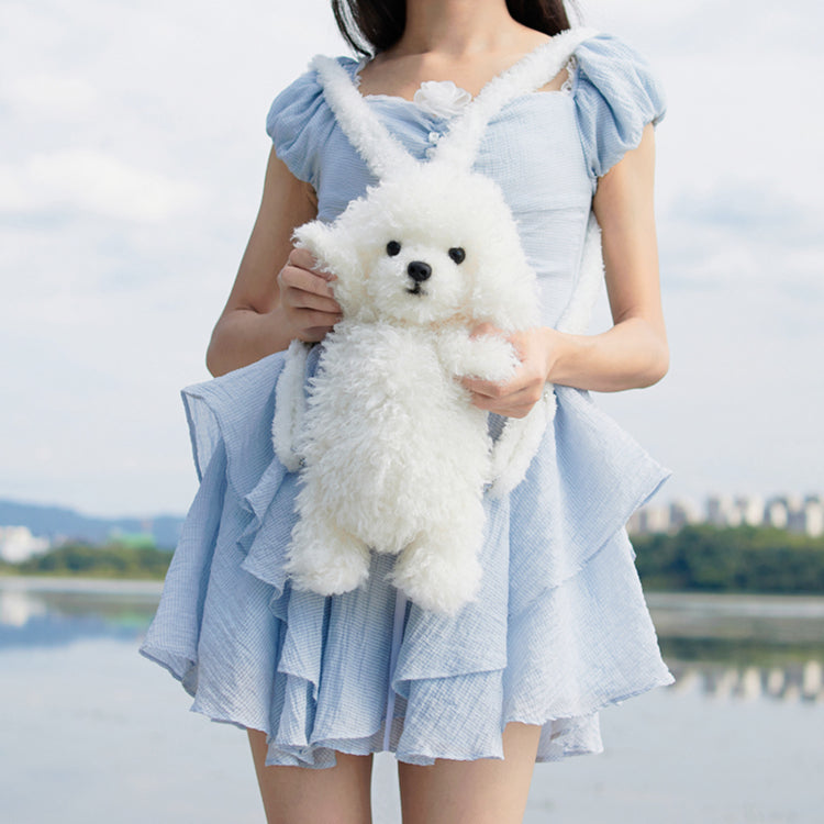 White plush puppy backpack with face detail and soft body, carried as a bag pouch