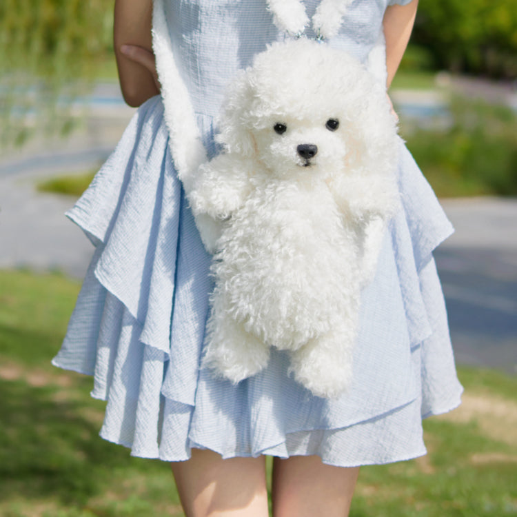 White furry puppy-shaped backpack with black nose and open mouth, held in front