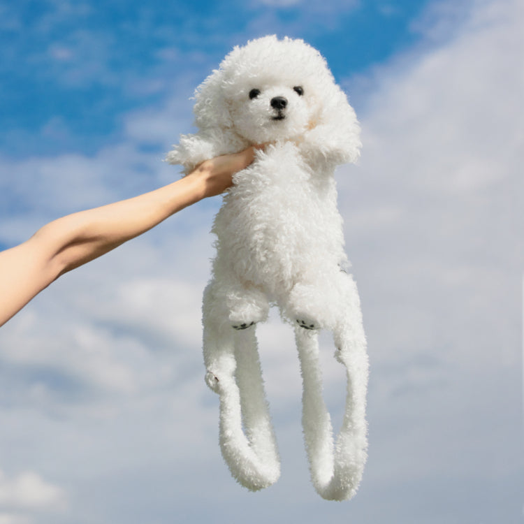 White plush dog backpack figure with button eyes and hanging legs, shown upright