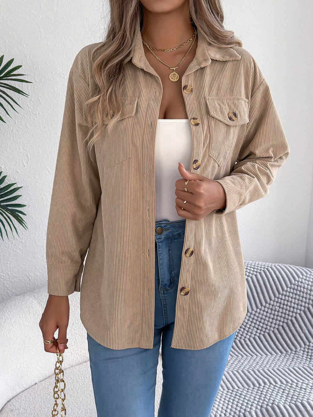 Khaki corduroy button-up shacket with point collar, button front, and chest pockets.