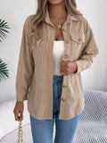 Khaki corduroy button-up shacket with point collar, button front, and chest pockets.
