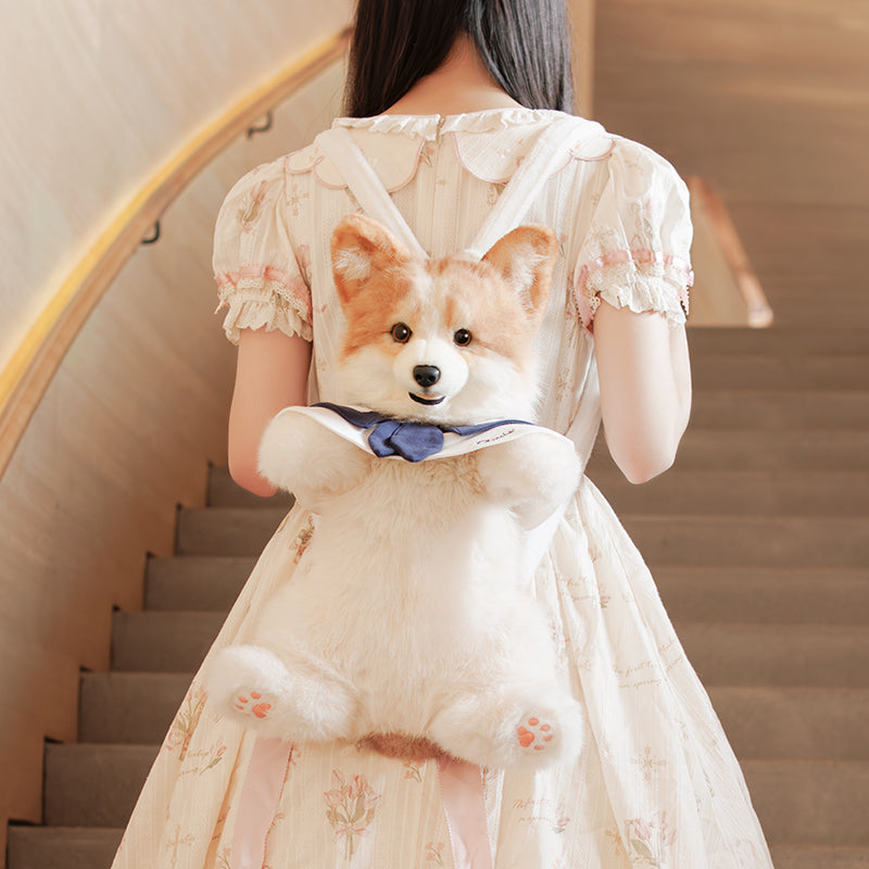 Corgi plush backpack on stairs, showing plush corgi face and navy bow front