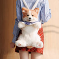Corgi plush backpack with white faux-fur body, navy bow, and striped strap