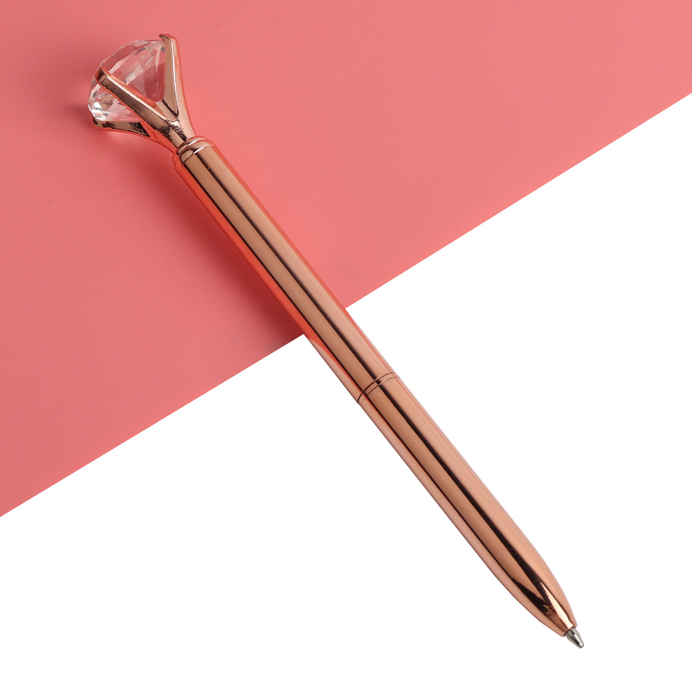 Rose gold gem-top metal ballpoint pen with faceted cap and polished barrel