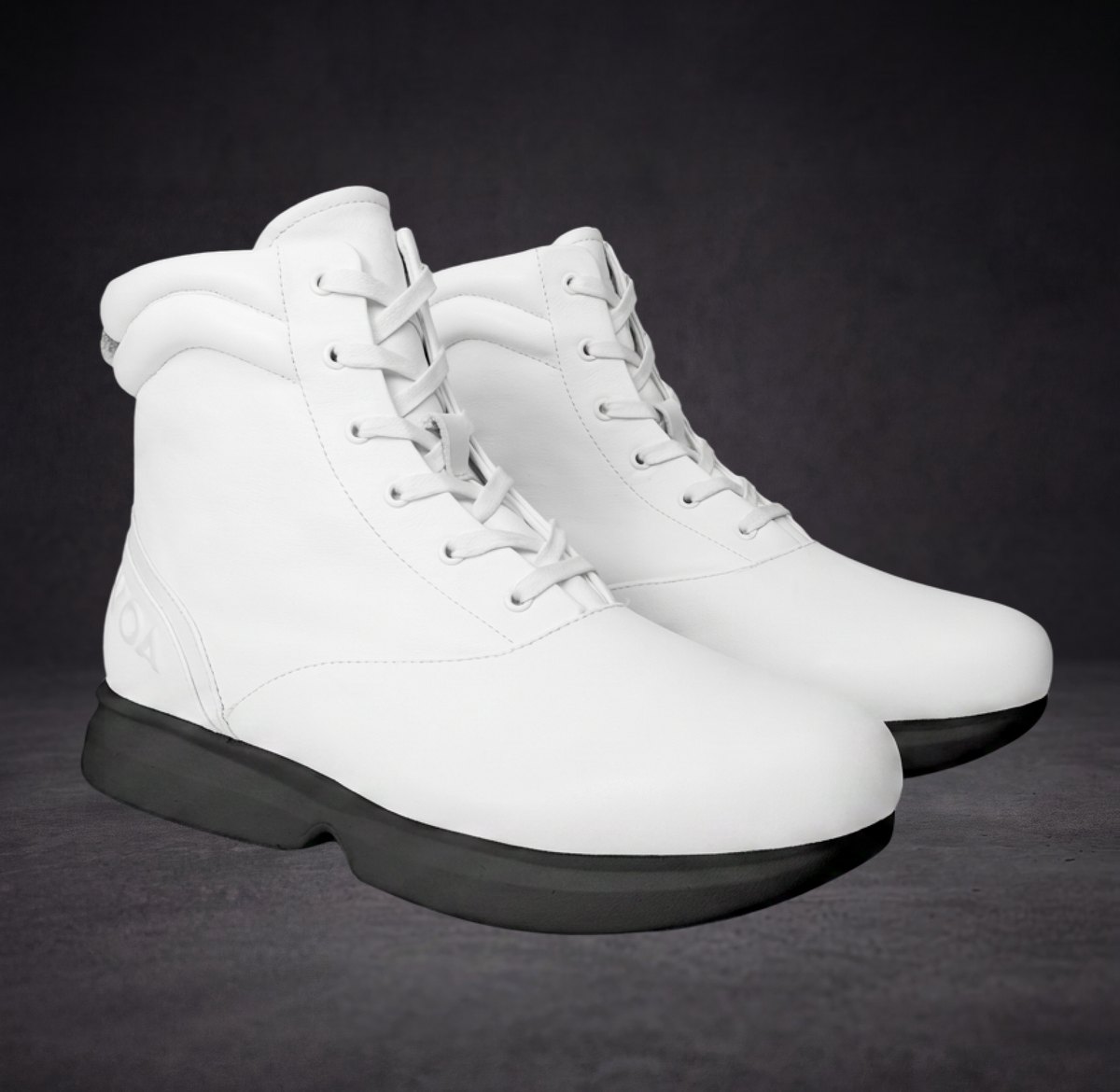 White WOA boot pair, lace-up high-top style with black cushioned outsole