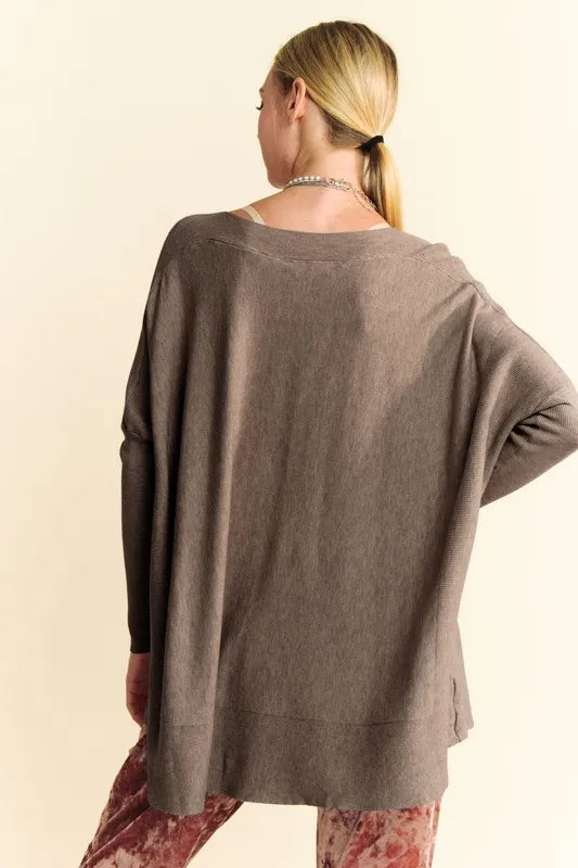 Coffee brown knit top with round neckline, dropped shoulders, and long sleeves
