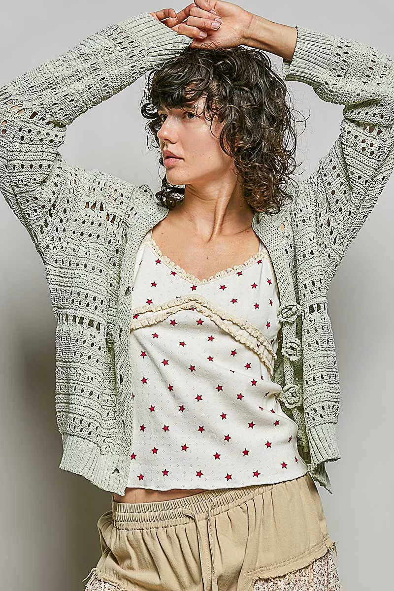 Light gray open-knit cardigan, back view with floral button placket