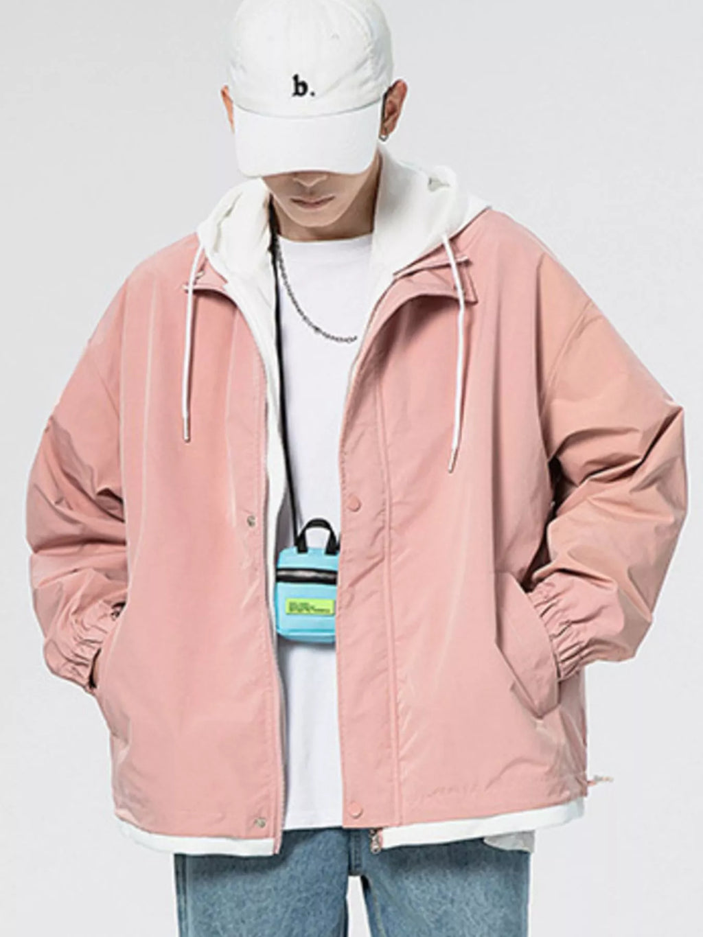 Pink windbreaker jacket with hood, front zipper, and side pockets; ribbed hem