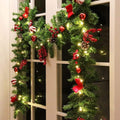 LED Christmas garland with pine tips, red berries, bows, and warm white light strands