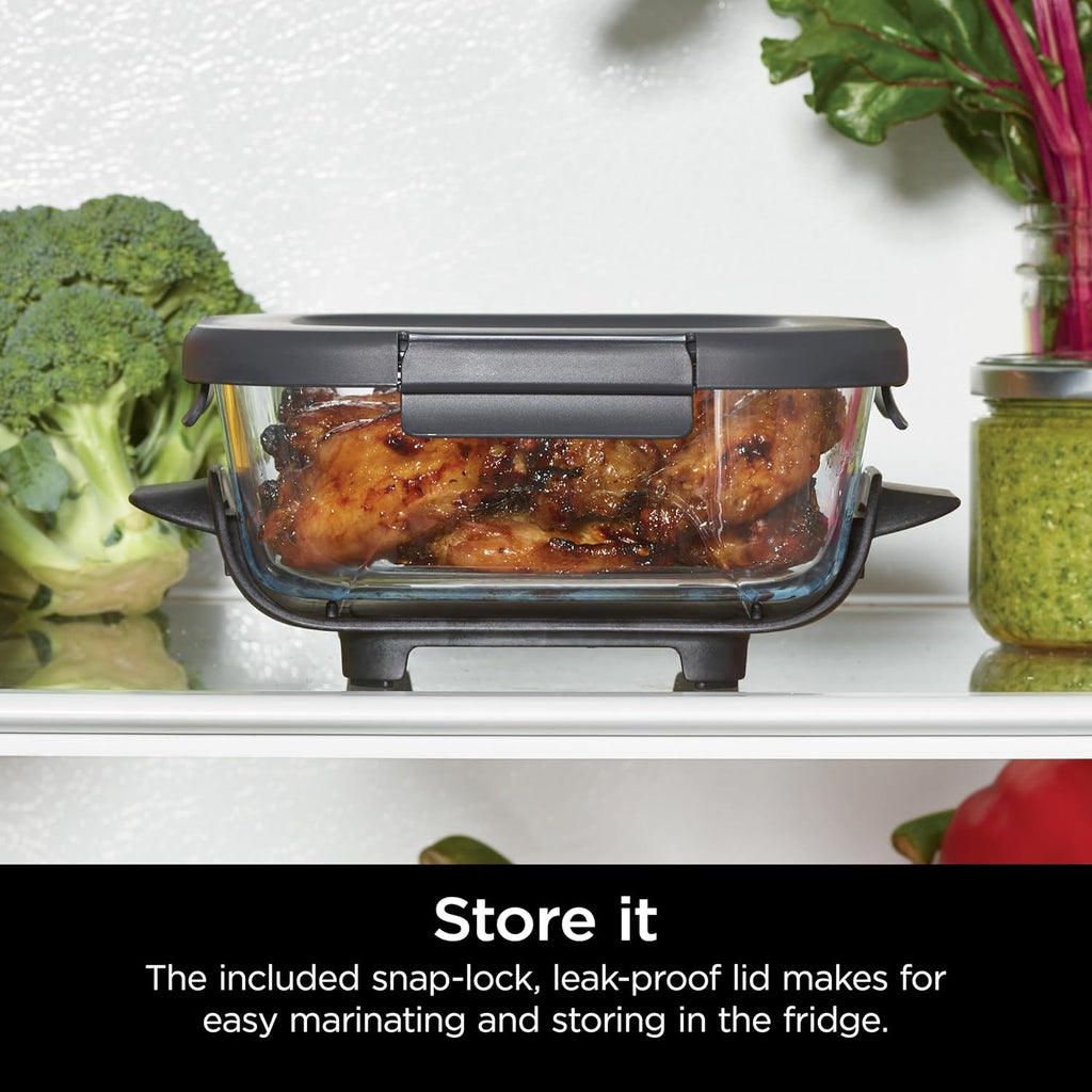 Clear glass container with snap-lock lid on a crisper plate, ready to store