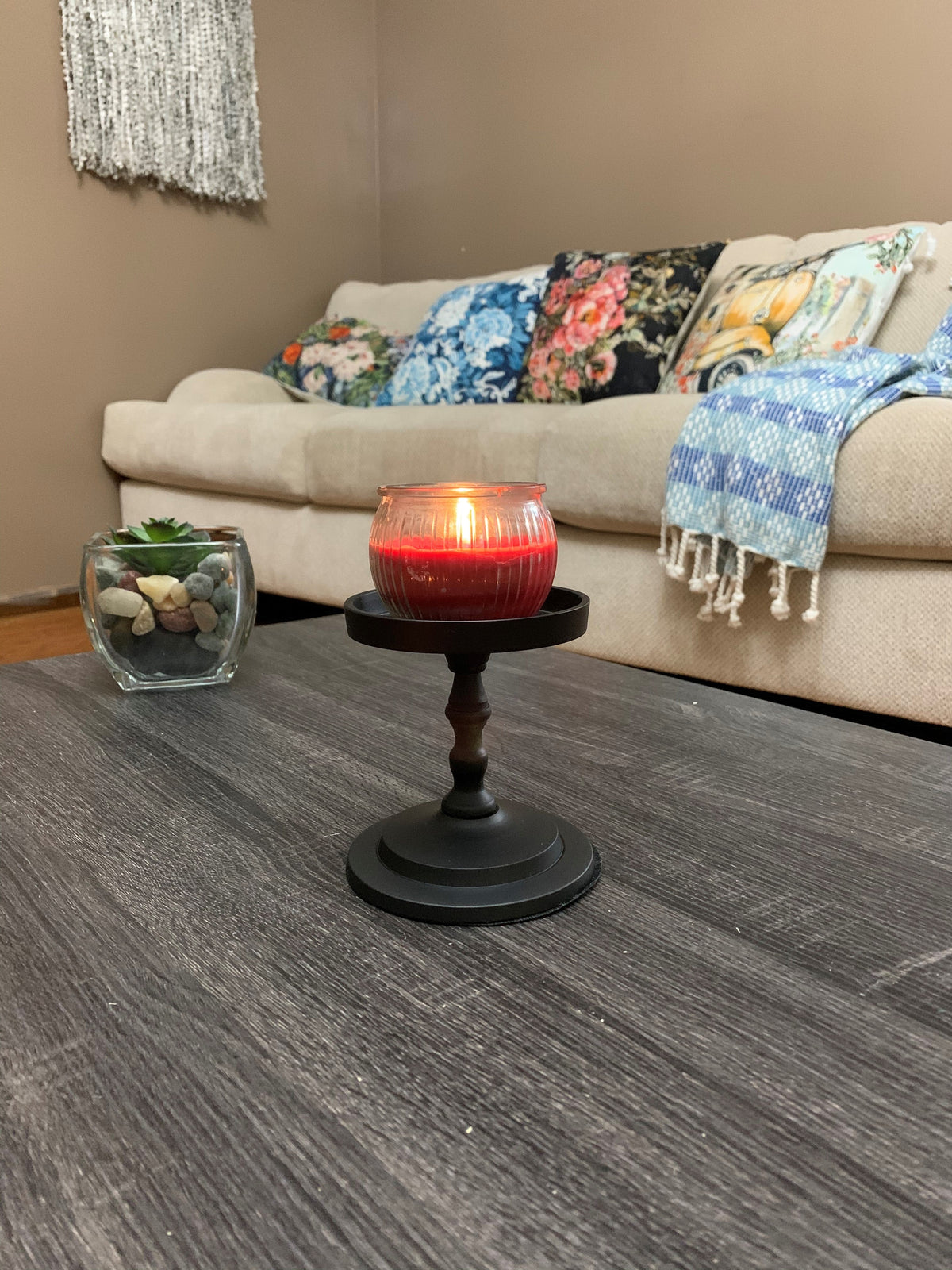 Matte black pillar candle holder with red glass-topped candle