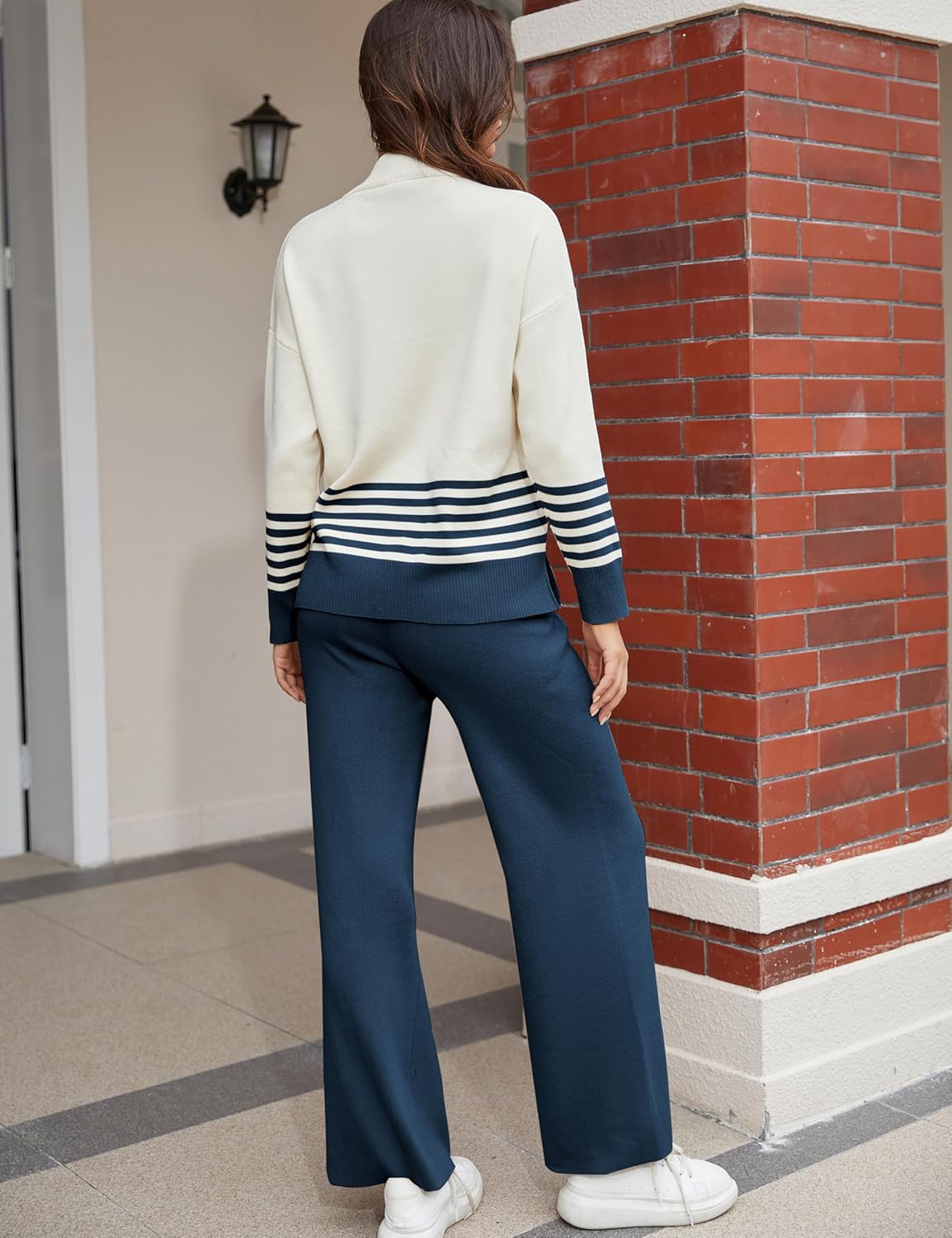 Women's lounge set back view: cream pullover with navy stripe hem, wide-leg navy pants