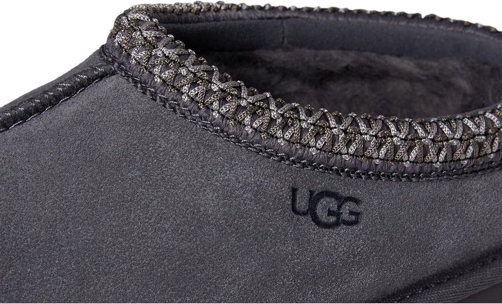 Kids' UGG Tasman II slipper close-up, woven collar edge and dark suede upper