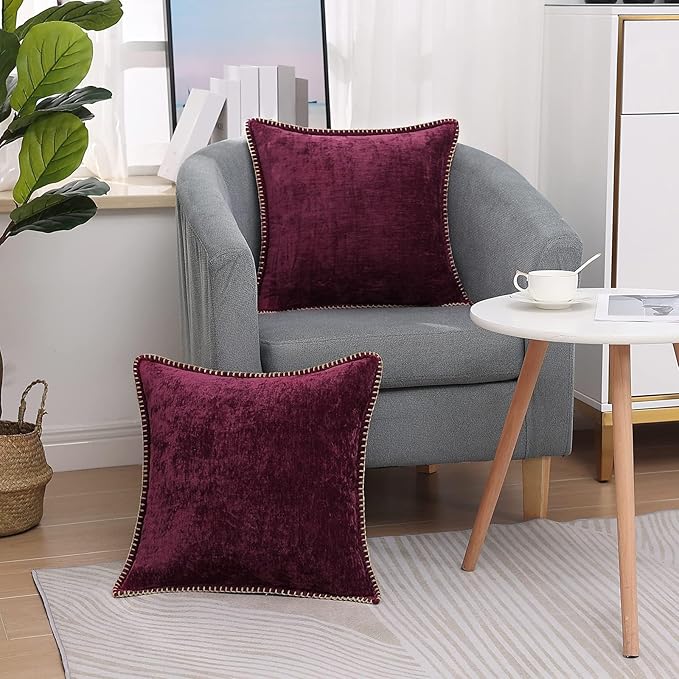 Plum chenille euro pillow cover with piped trim on a couch armchair
