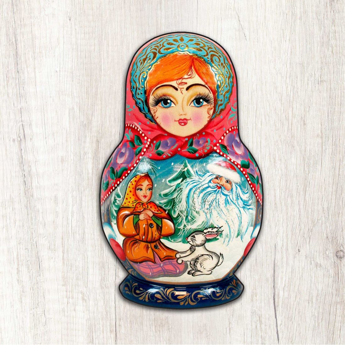 Painted nesting doll ornament featuring red-haired woman, blue headscarf, and white bird