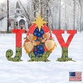 Outdoor “JOY” nativity yard decor with angels and a yellow star, red and green accents.