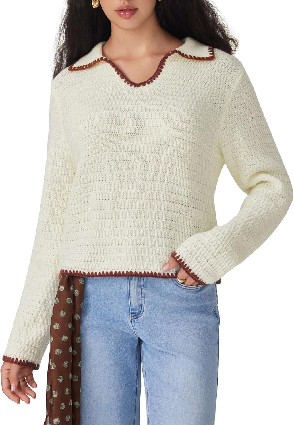 Beige V-neck knit sweater with long sleeves and contrast trim, worn with blue jeans