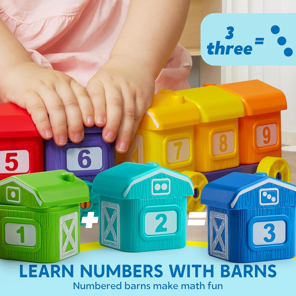 Close-up of hands placing numbered barn blocks on a colorful farm train car
