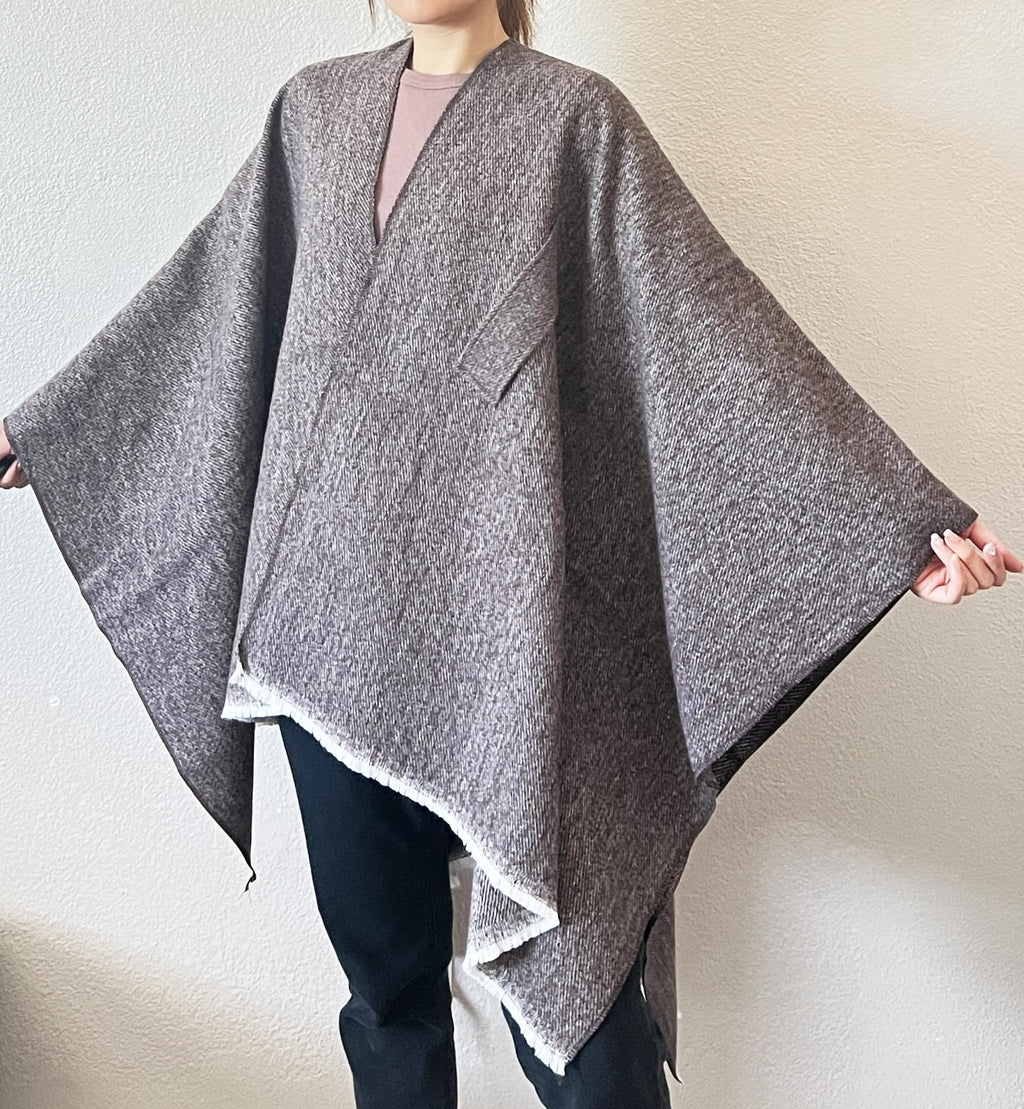Dark heather gray open-front fringe poncho shawl with draped sides and tied knot