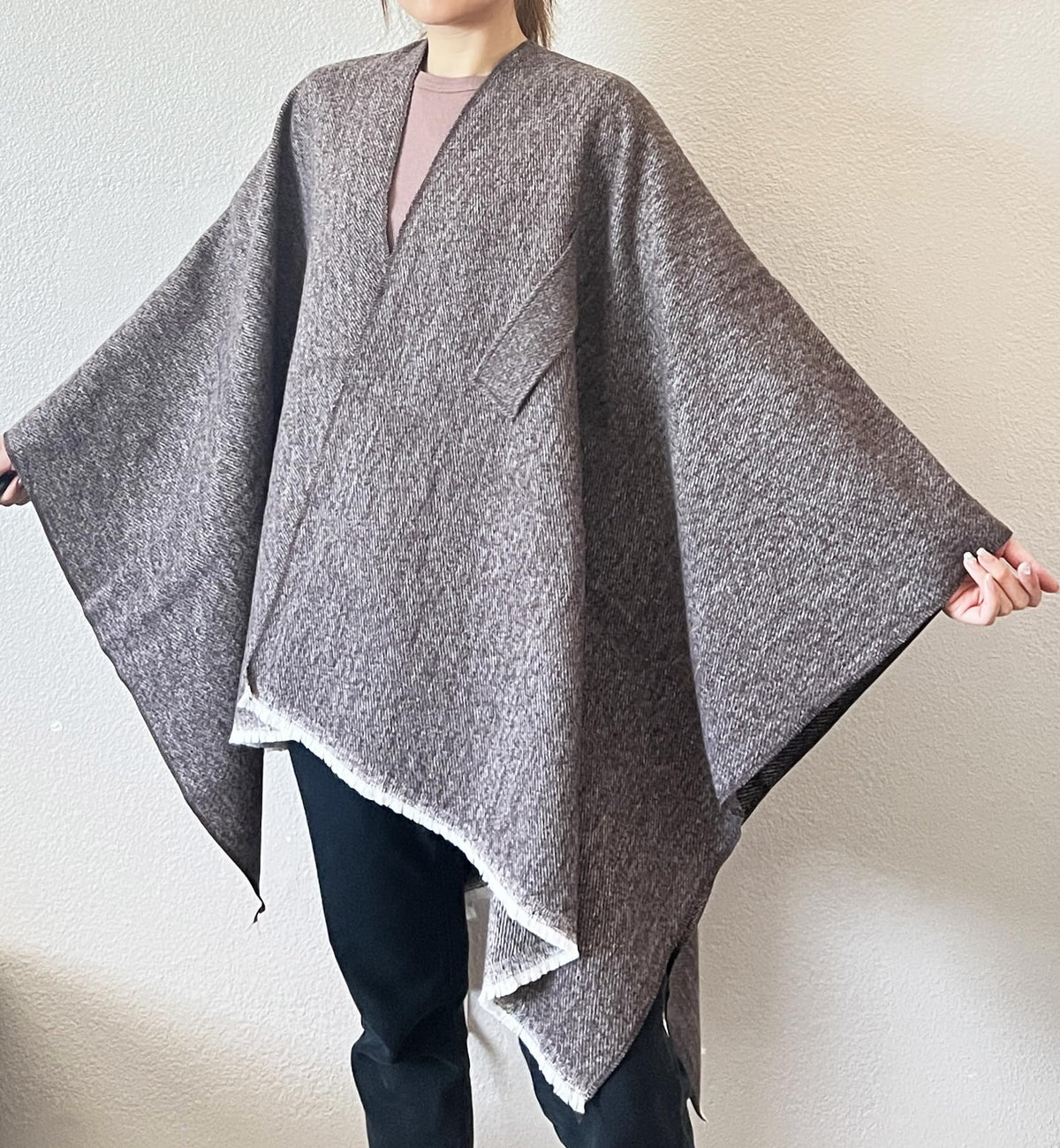 Dark heather gray open-front fringe poncho shawl with draped sides and tied knot