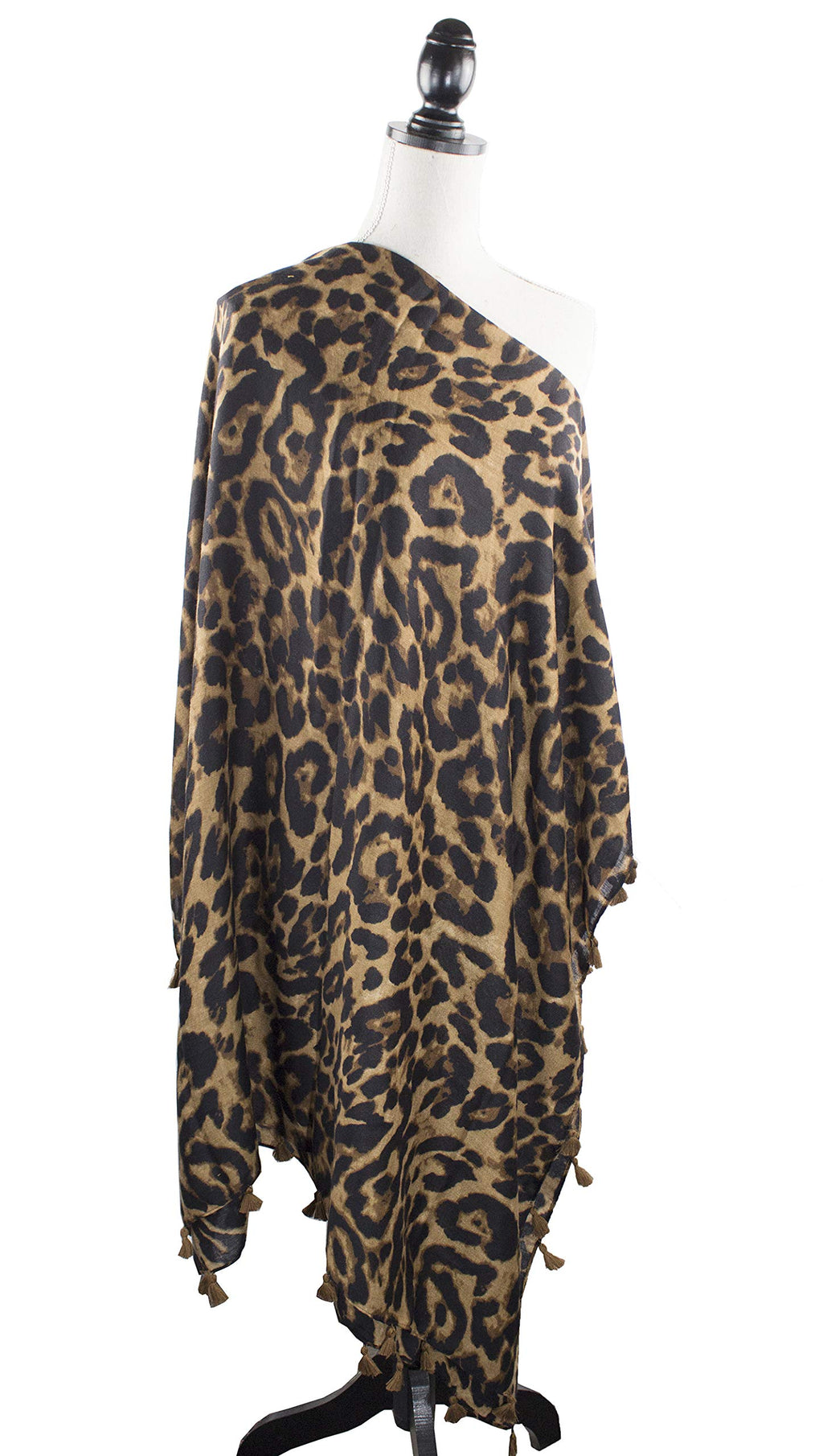 Leopard print scarf wrap with tassel trim and flowing drape on a mannequin