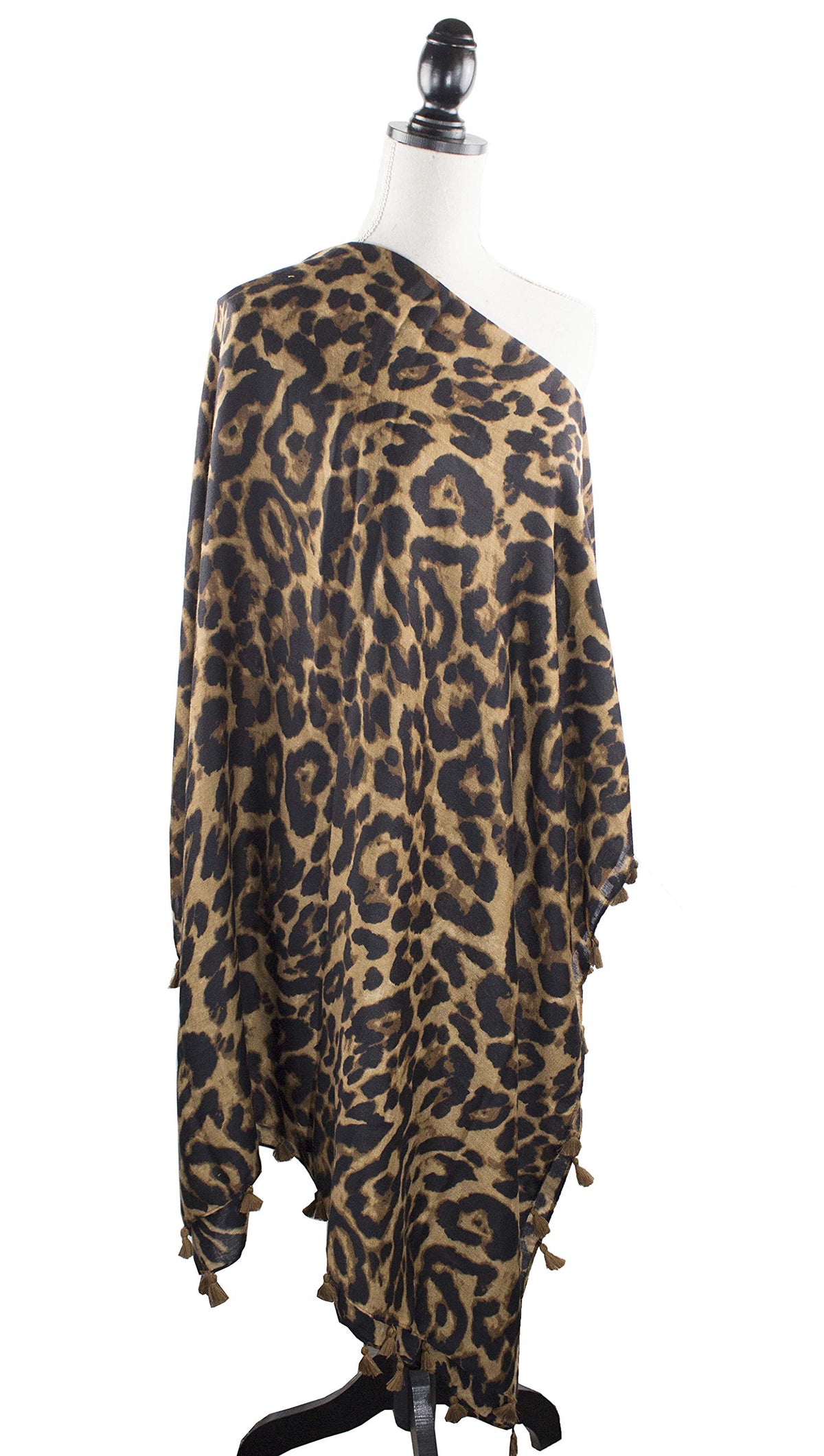 Leopard print scarf wrap with tassel trim and flowing drape on a mannequin