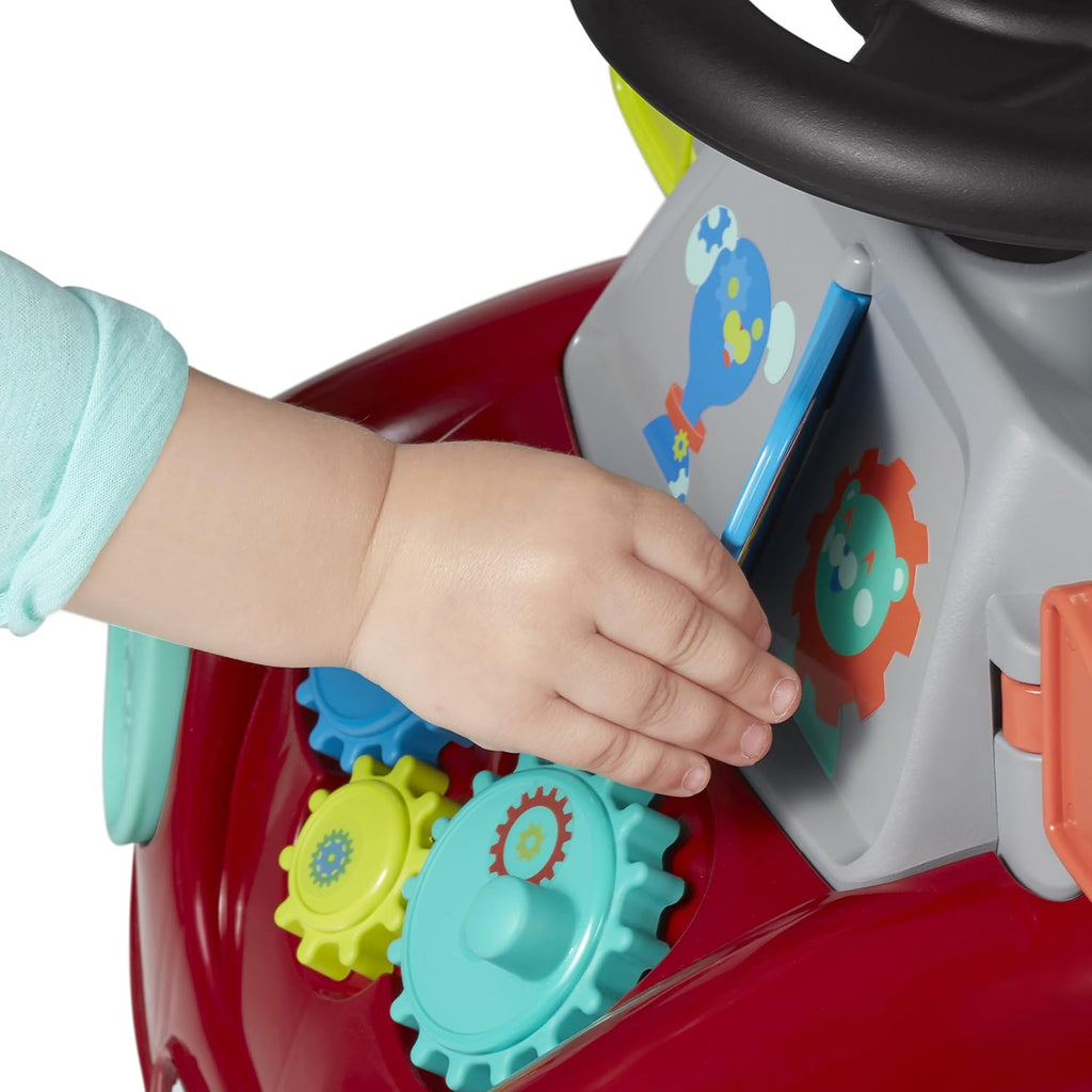 Red ride-on car side play panel with colorful gear buttons and a child hand pressing them.