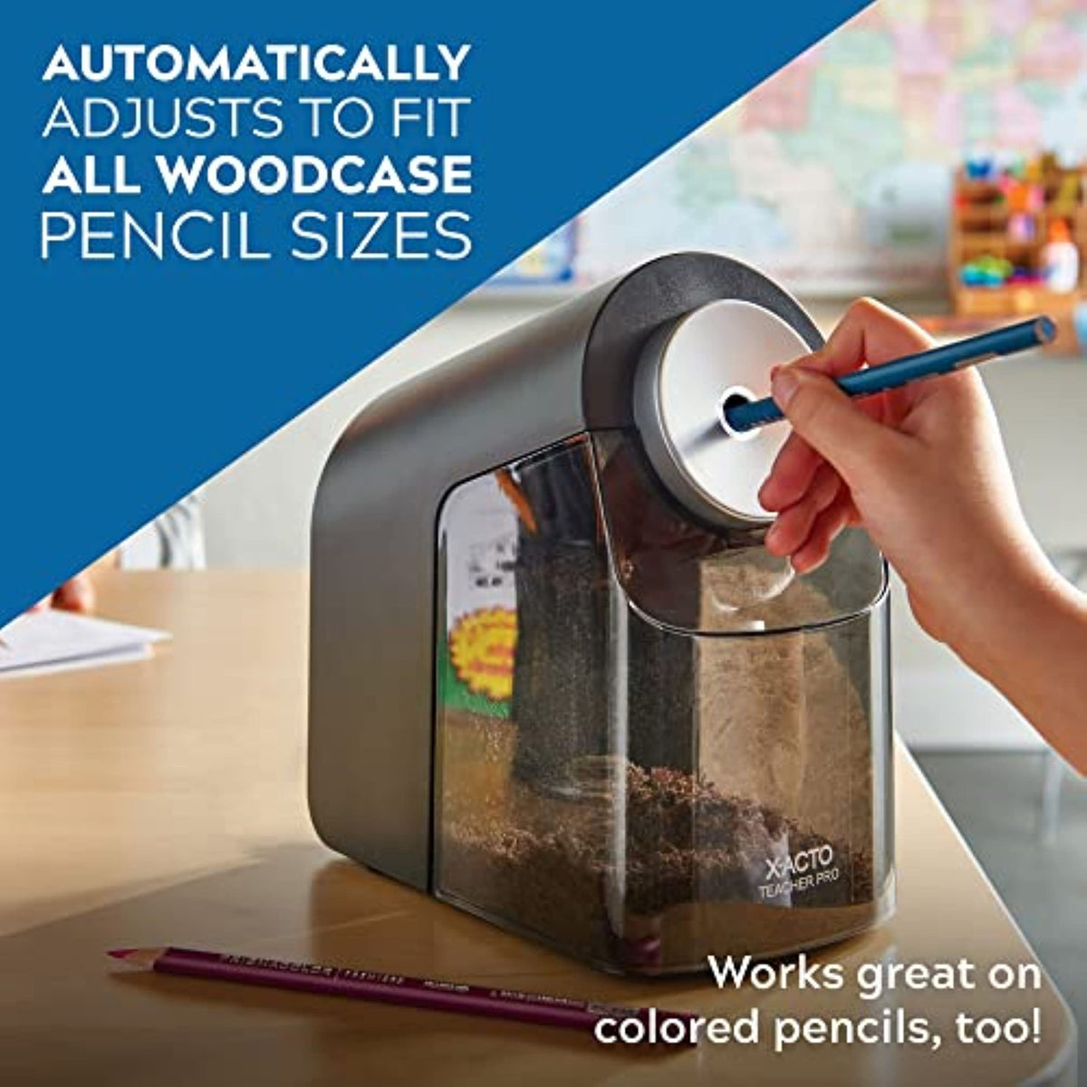 Black electric pencil sharpener with hand holding pencil at round silver dial and clear bin.