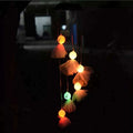 Solar LED wind chime with glowing pumpkin-like hanging light shades