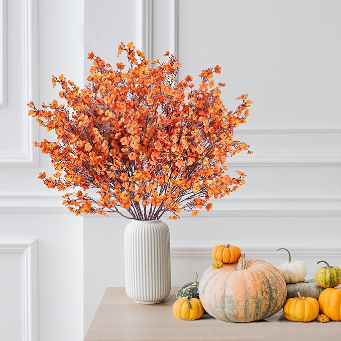 Orange artificial baby's breath bouquet in white ribbed vase